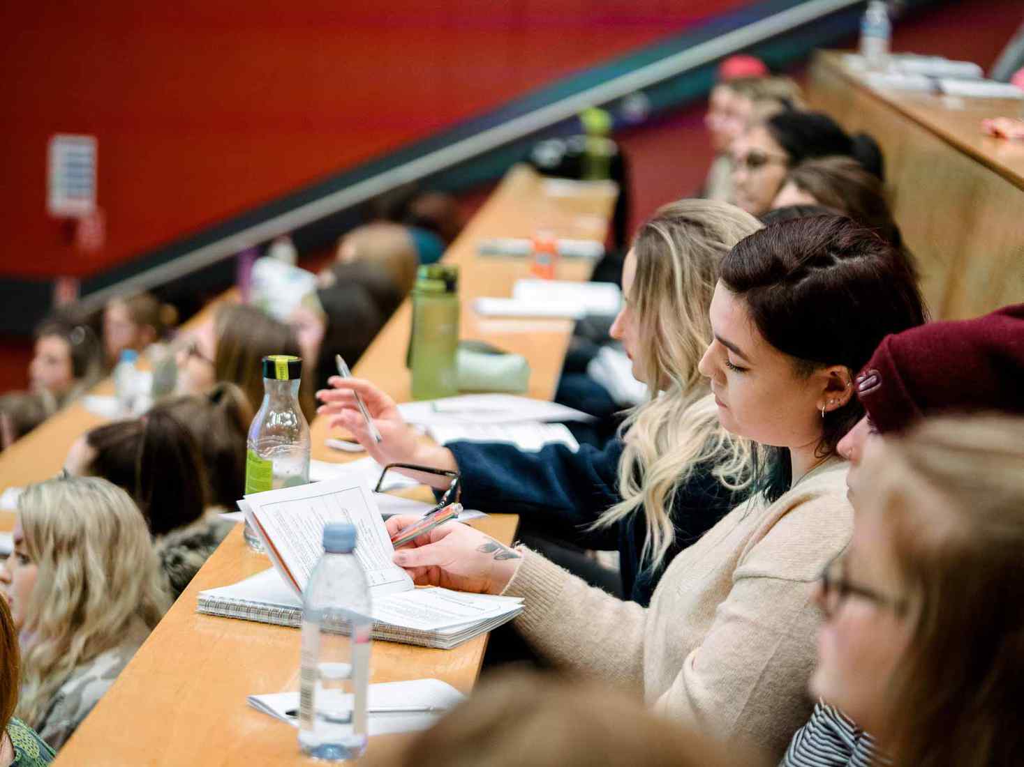 Students taking notes in lecture theatre during Careers talk 