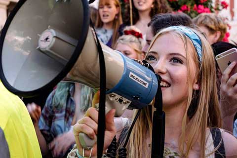 Student using megaphone at climate change protest in York 