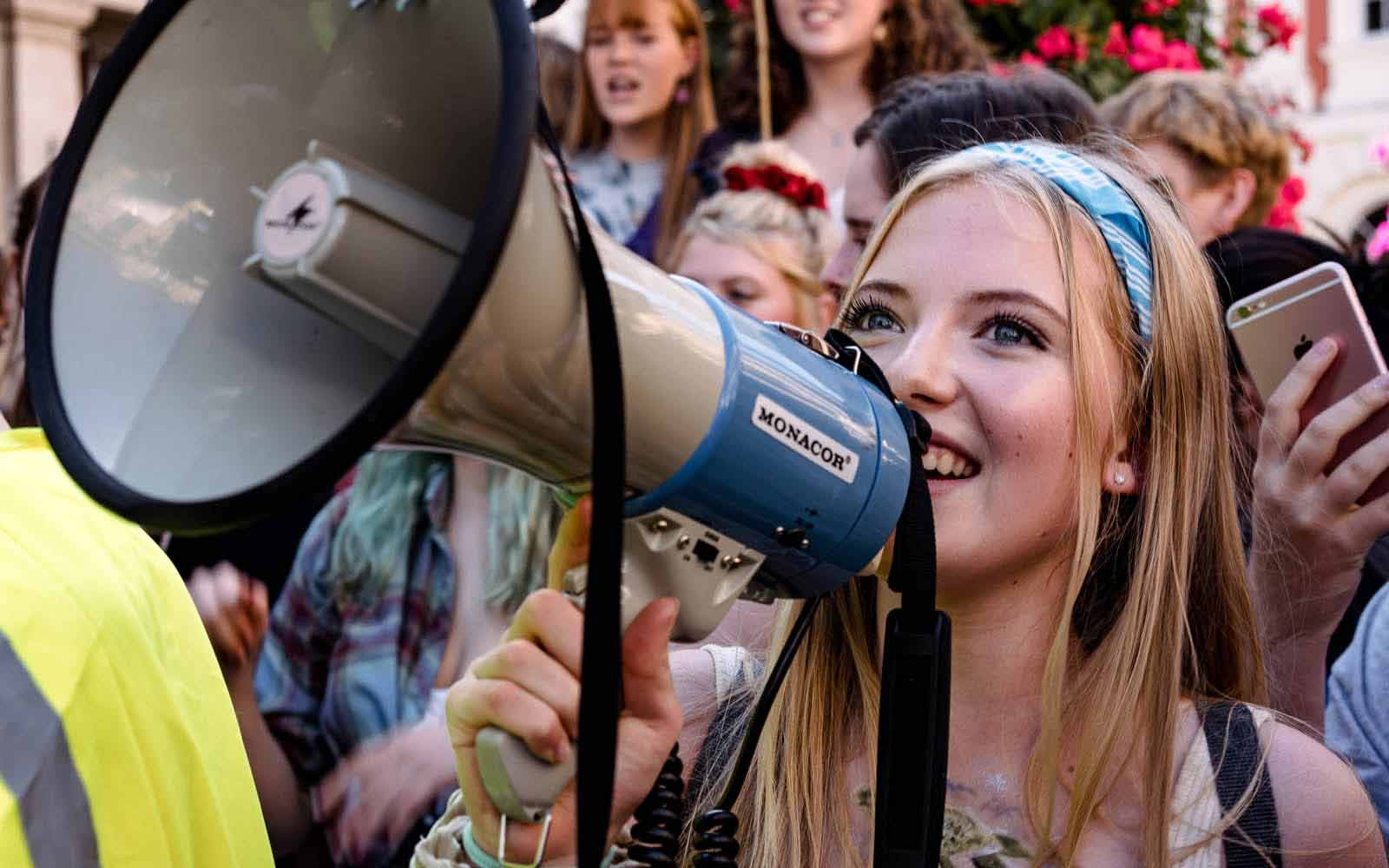 Student using megaphone at climate change protest