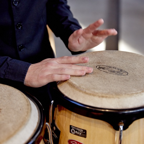 Hands playing a drum 