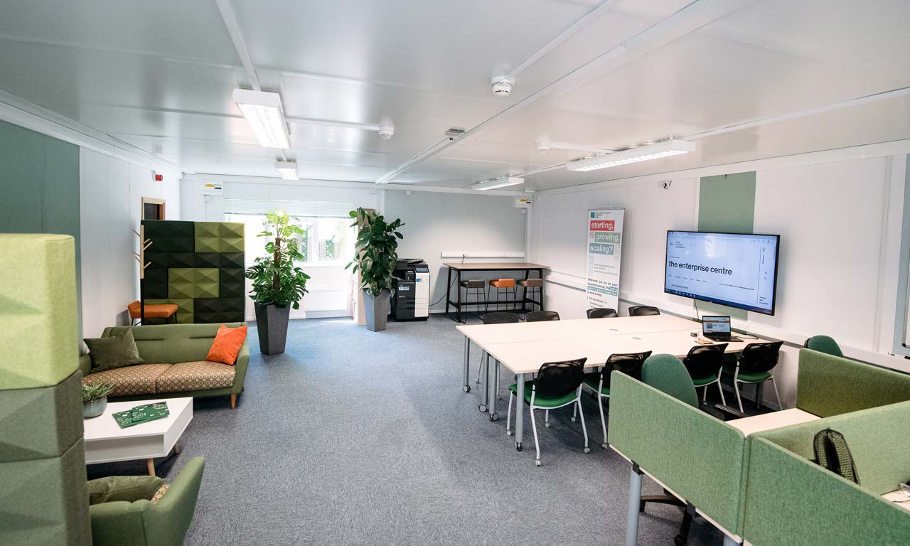 Room in Enterprise Centre with different workspaces, sofa areas and tables. 