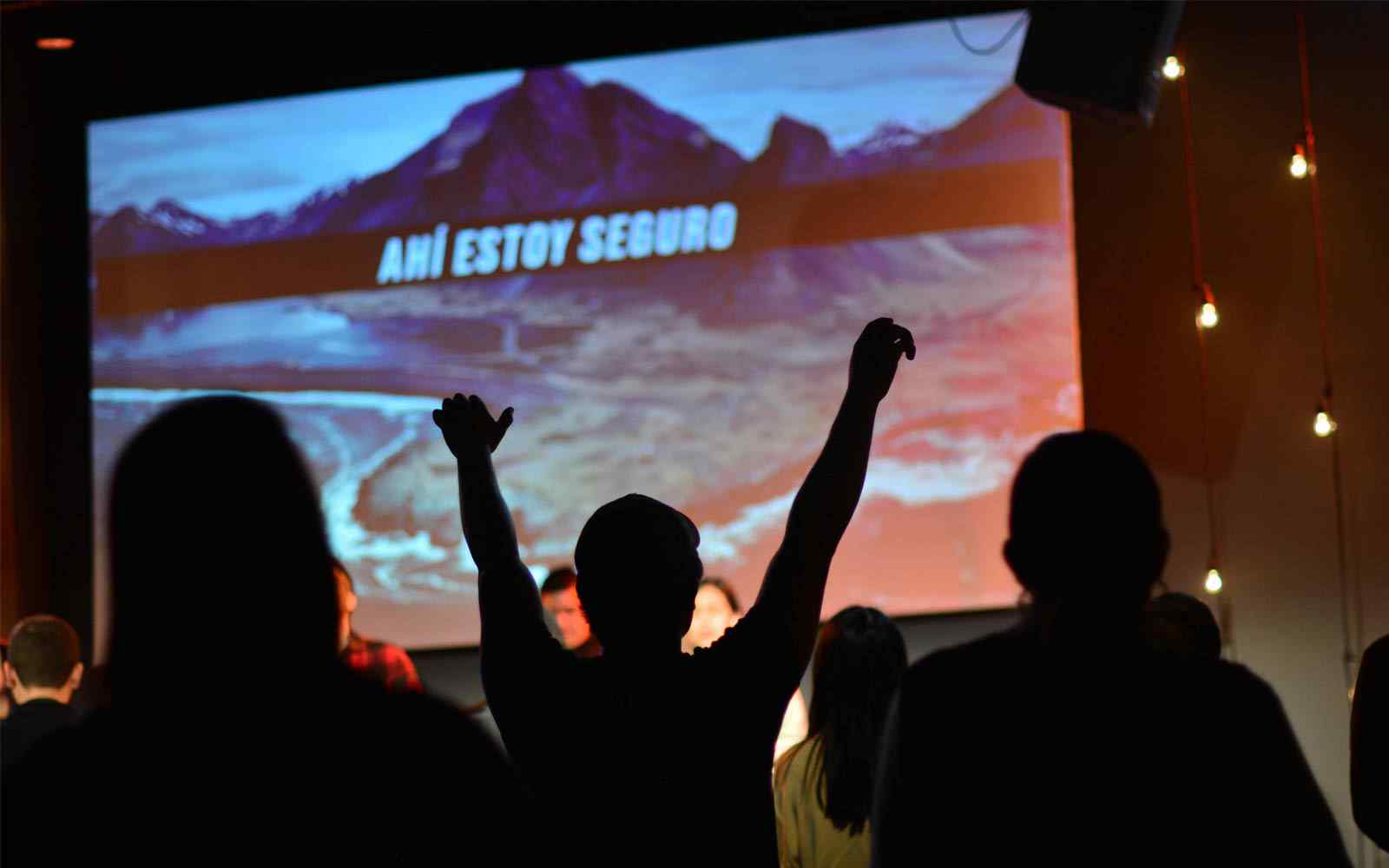 People silhouetted against a screen at a film screening. 