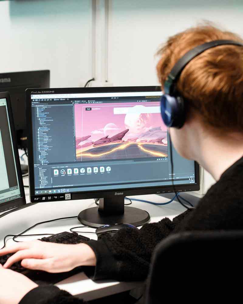 Student working on computer to design game 