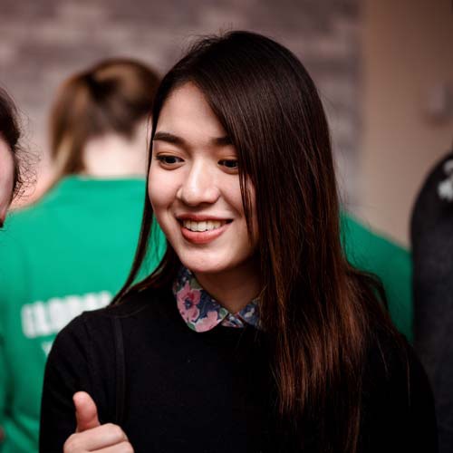 Student smiling at a global campus event 