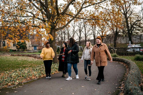 5 students walking onto York St John University campus in the Autumn 