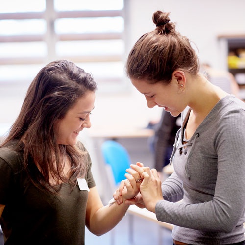 Health students examining wrist 