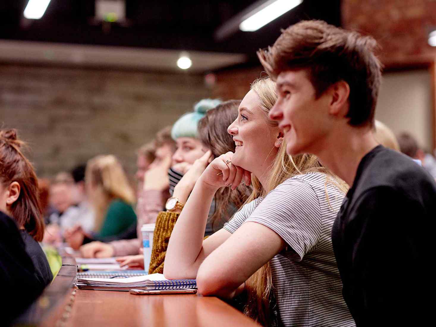 students in a lecture. They are smiling  