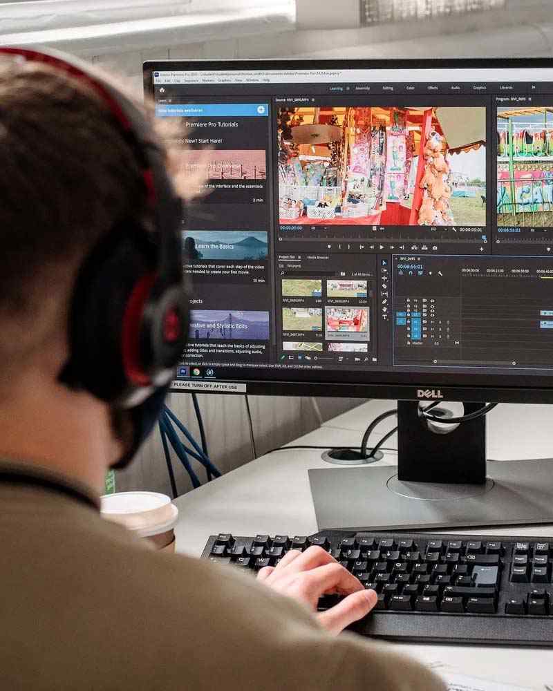 A student edits videos for media production course. 