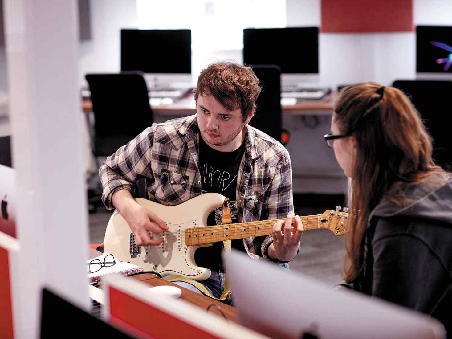student playing the guitar  