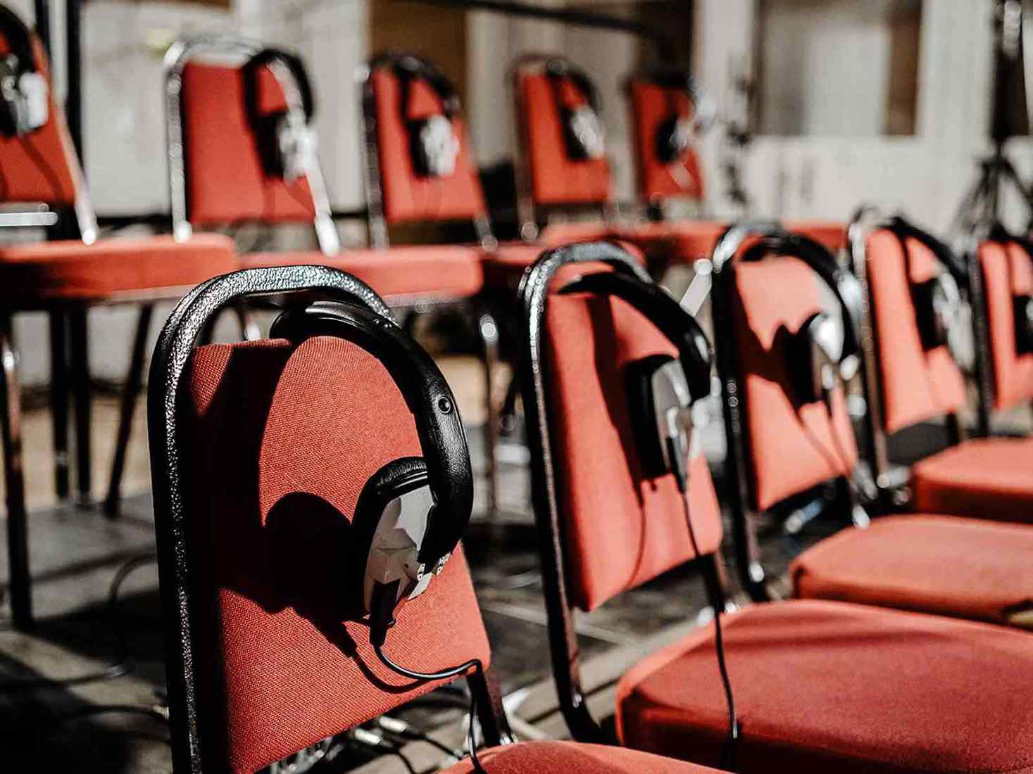 View of chairs and headphones in a recording studio. 