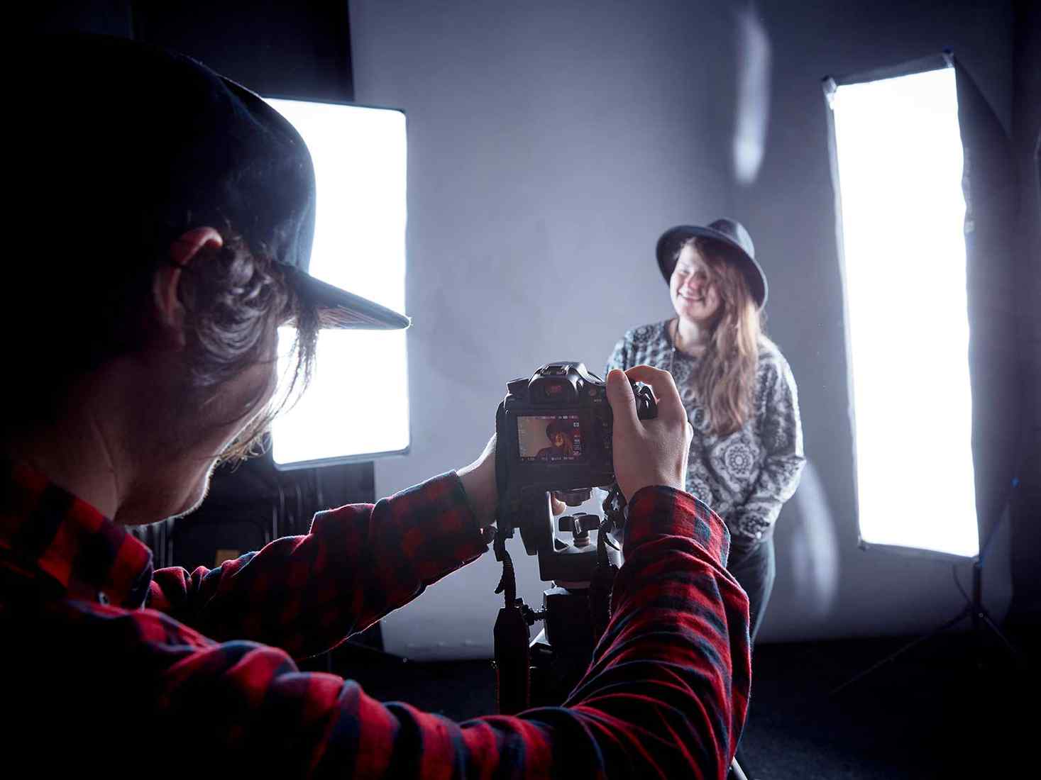 A student being photographed in a studio 