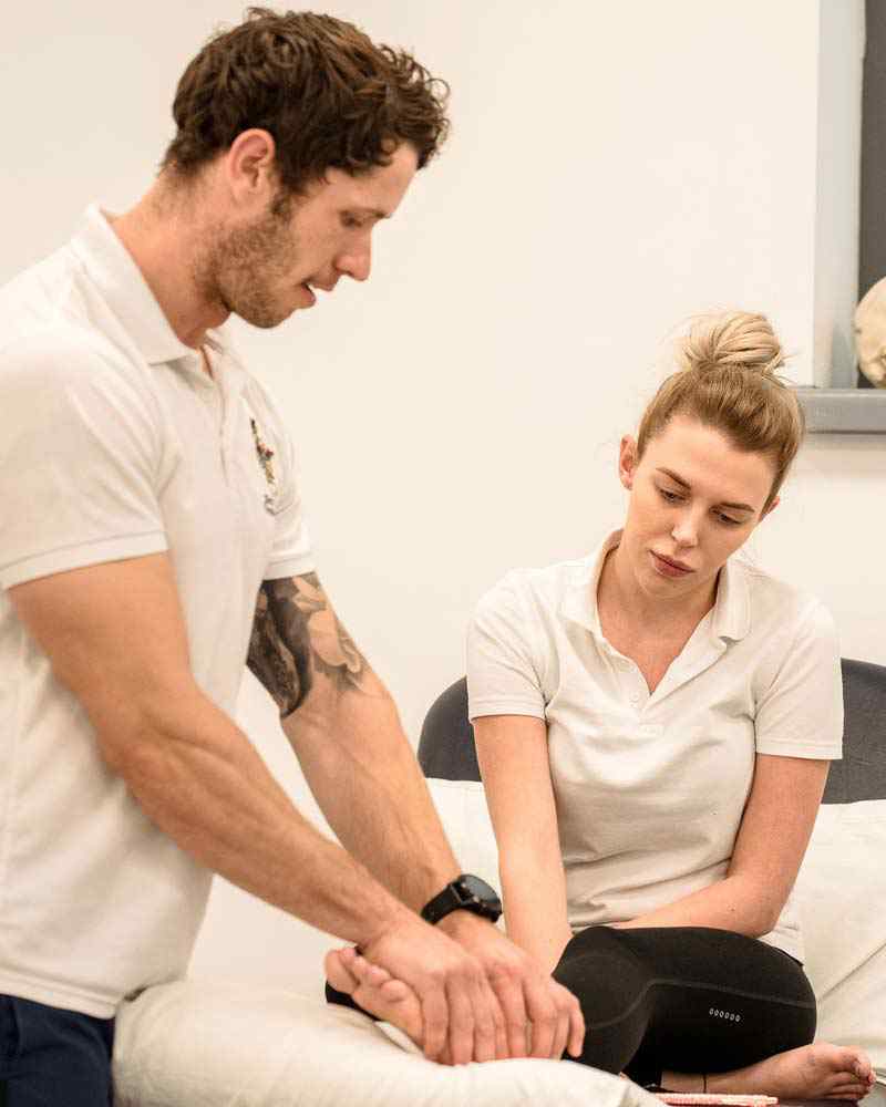 Students work together in a physiotherapy class. 