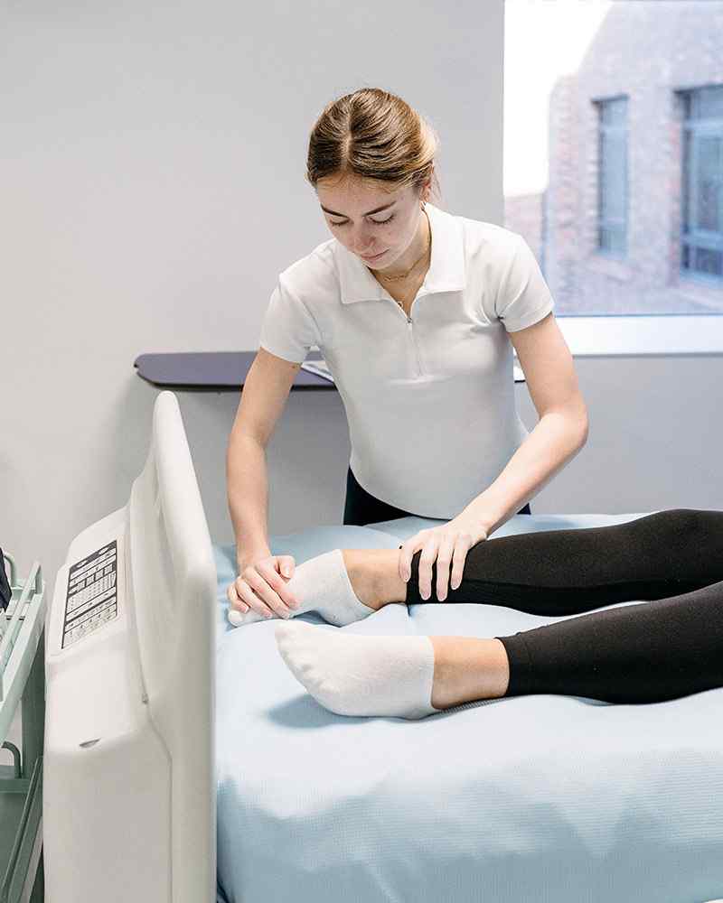 Physio student working on leg 