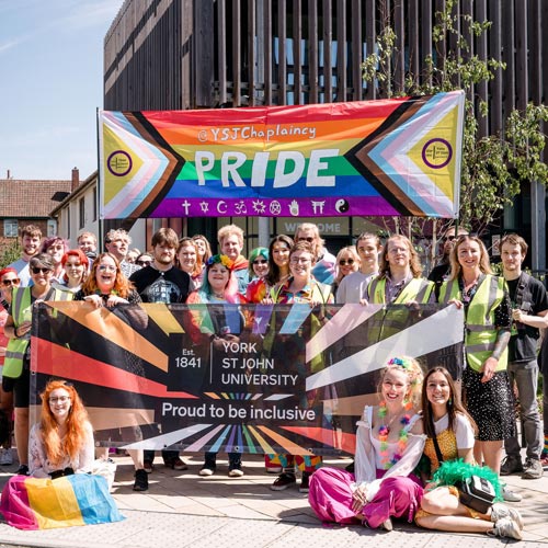 Group of students with Pride banners 