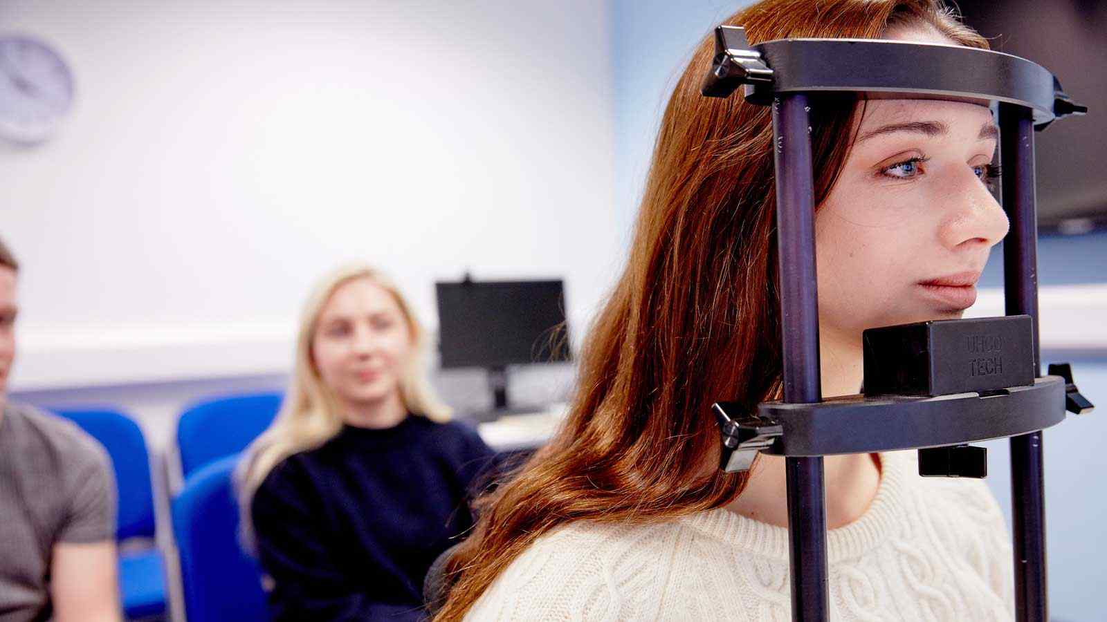 Two psychology students work with specialised equipment. 
