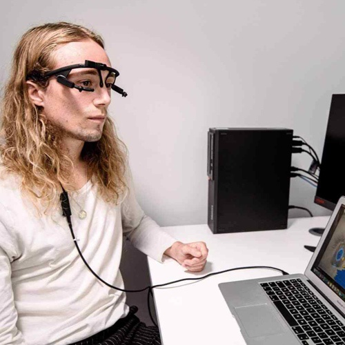 A psychology student uses eye-tracking equipment. 