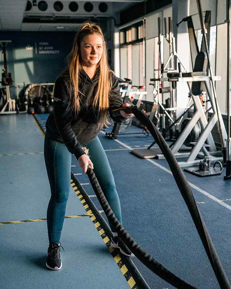 Sport student using gym equipment 