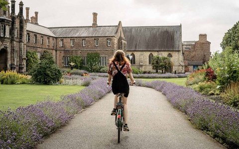 Student cycling across campus 