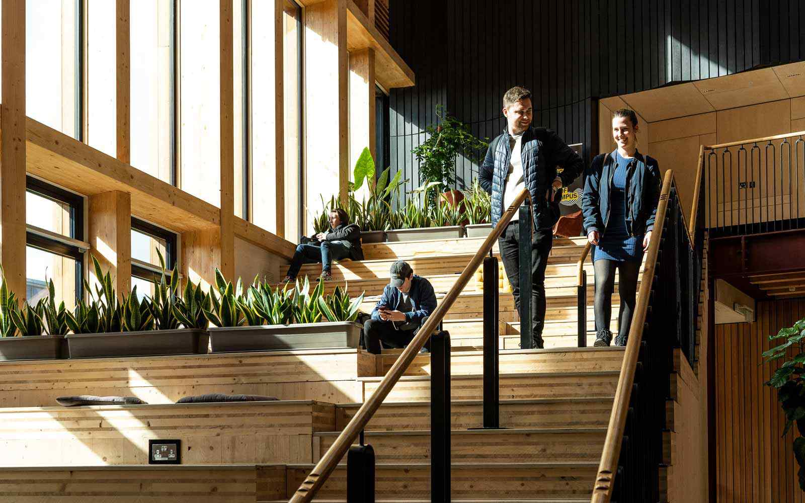 Students walking down steps in Creative Centre atrium 