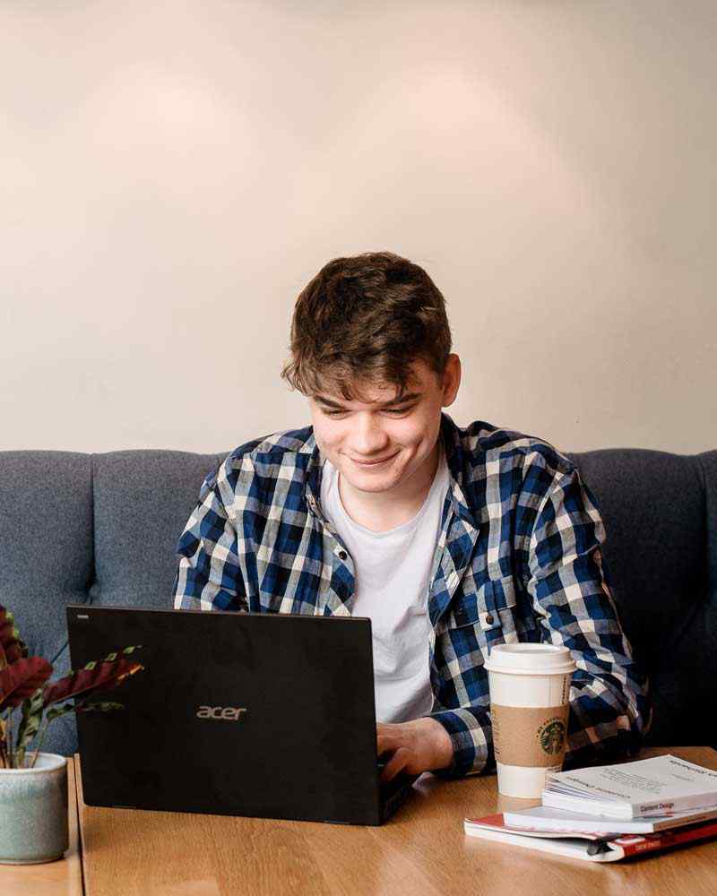 Student on laptop studying in Students' Union 