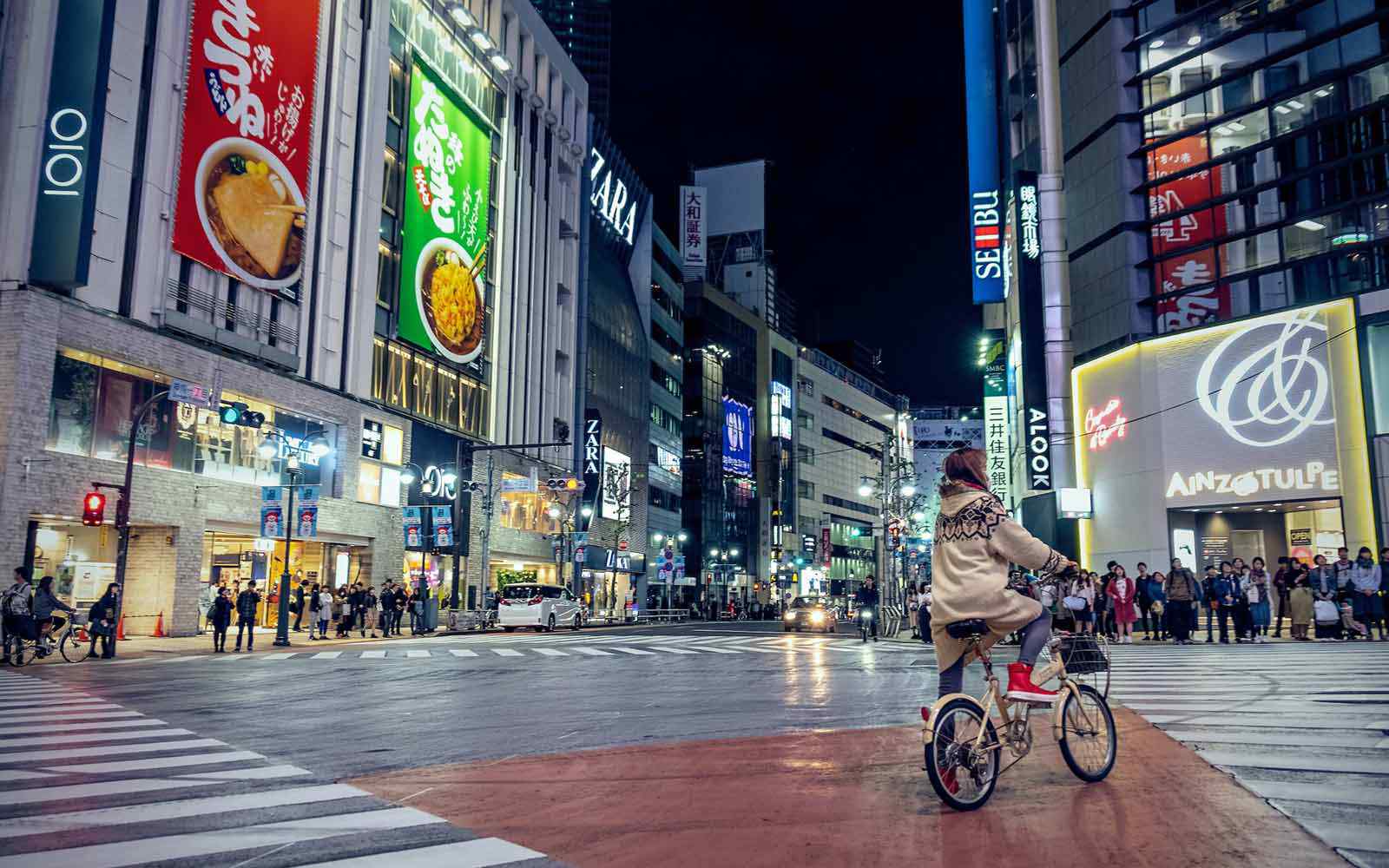 Woman riding bicycle in Shibuya-ku, Tokyo, Japan. Photo by Bohdan Maylove on Unsplash. 