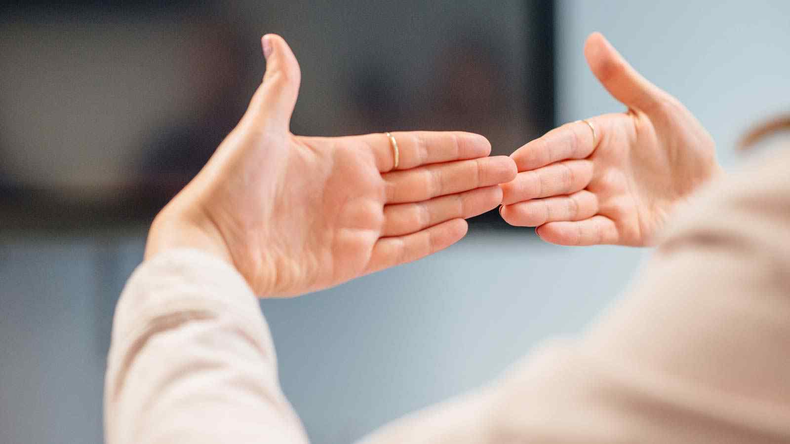 Hands signing in British Sign Language 